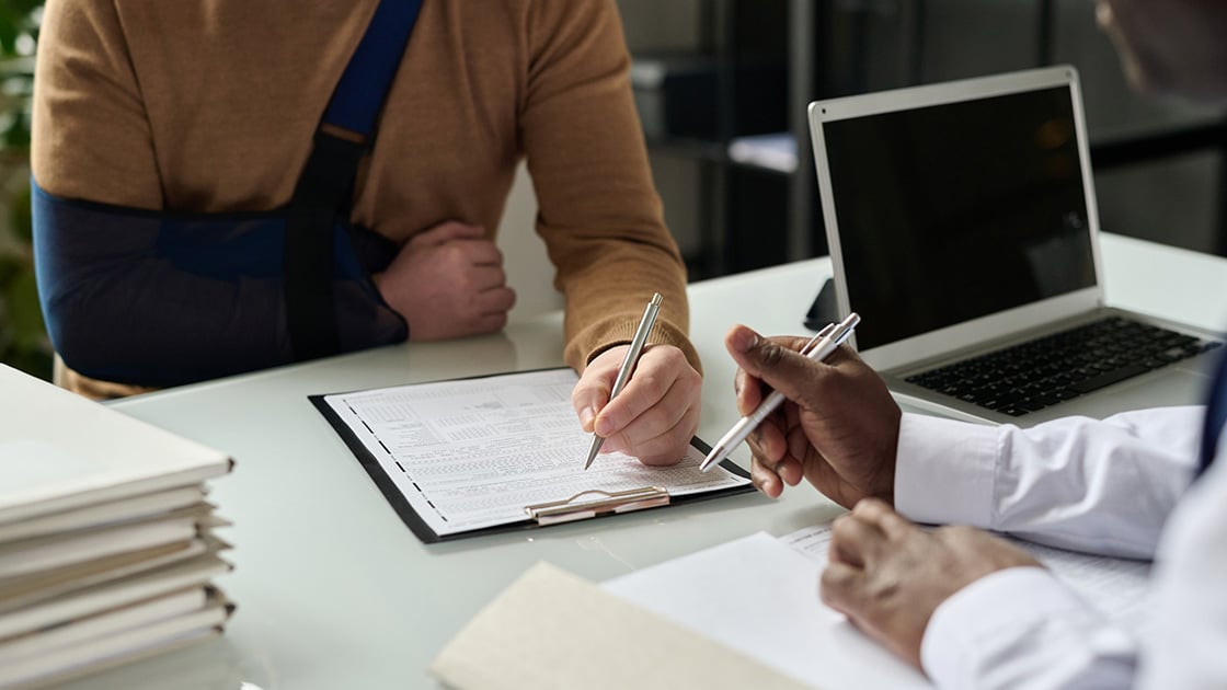 Man filling out insurance form
